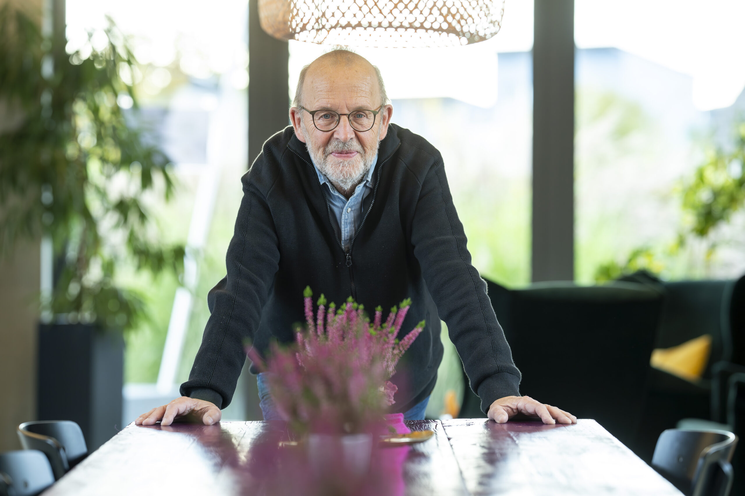 Vorträge Ralf Alef, an einen Tisch gestützt, Tageslicht